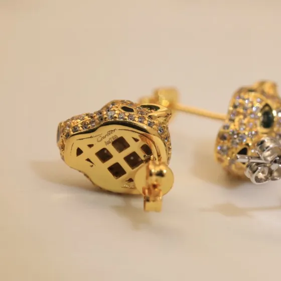 Cartier Panthere de Cartier earrings 18k yellow gold clear pave diamonds black onyx spots emerald green eyes 10mm stud length