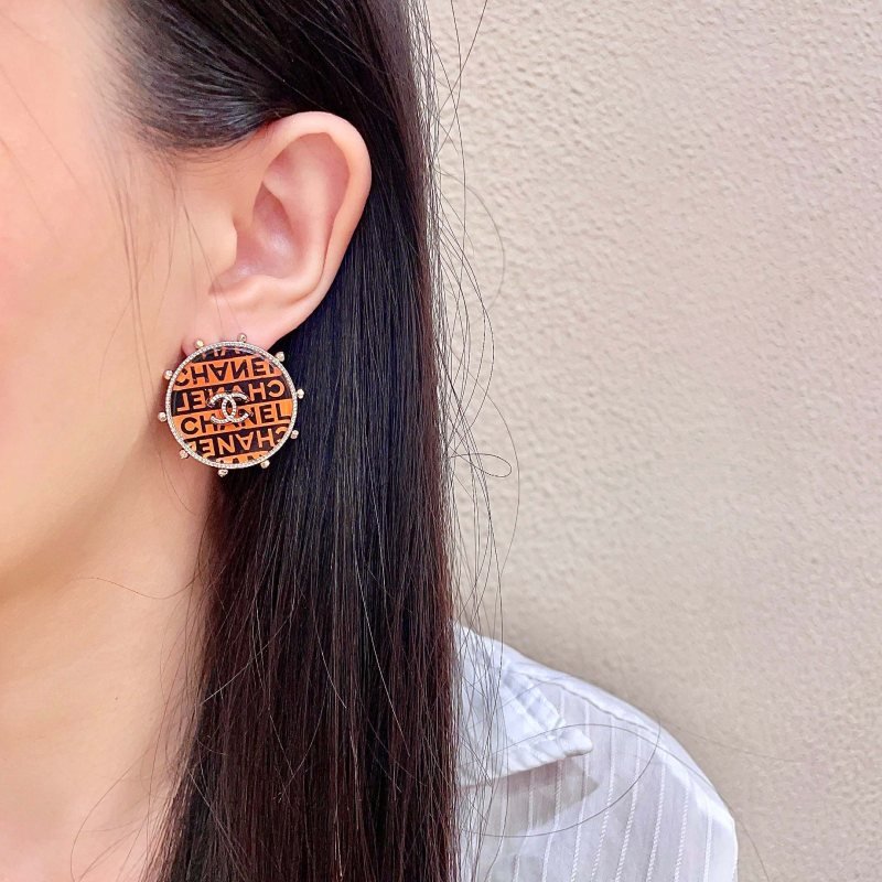Chanel CC Logo Round Printed Stud Earrings earrings Gold-tone metal with clear crystal accents orange and black enamel printed with Chanel text 2 5cm diameter
