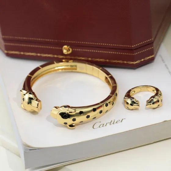 Cartier Panthere de Cartier bracelet 18K yellow gold with black lacquer spots and green tsavorite garnet eyes 17cm