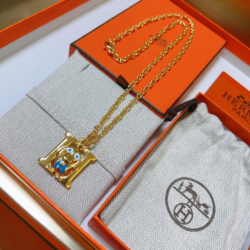 Hermes Quizz H Charm Monster Pendant necklace gold-tone metal with blue enamel accents white and blue enamel eye details 45cm