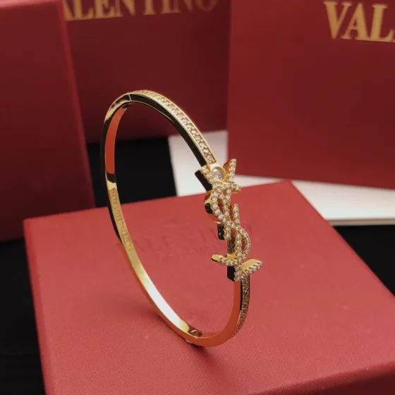 Saint Laurent Cassandre YSL Monogram Crystal Bangle bracelet gold-tone metal with clear crystal accents 17cm inner circumference
