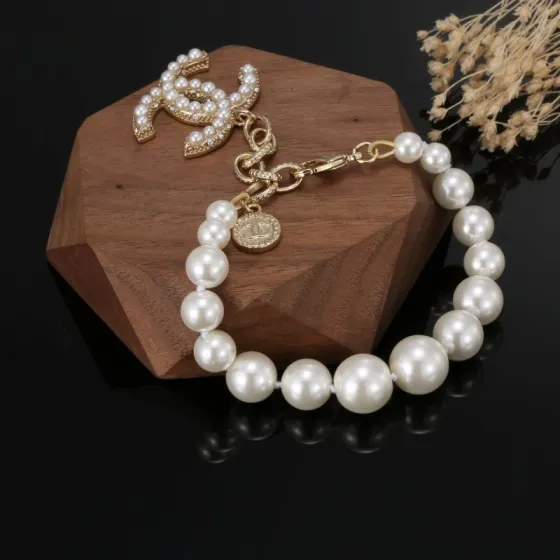 Chanel CC Pearl Charm Bracelet bracelet Gold-tone metal with white faux pearls and clear crystal accents 18cm