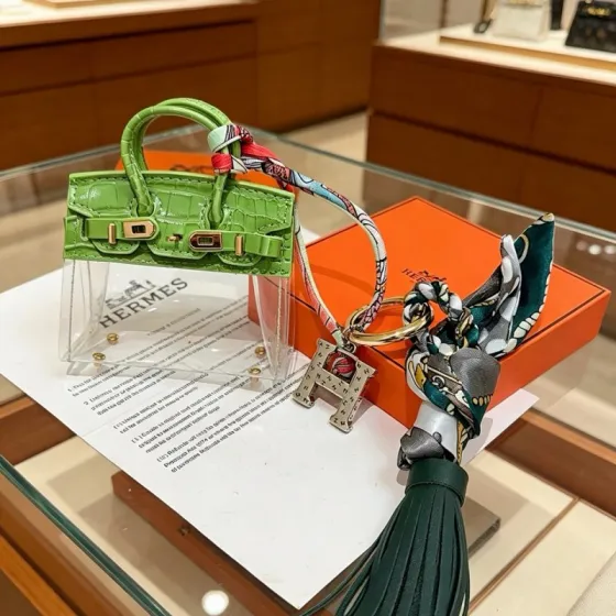 Hermes Birkin Bag Charm Keychain pendant Green crocodile-embossed leather gold-tone metal silver-tone metal multicolor printed silk dark green leather tassel clear vinyl 12cm total length