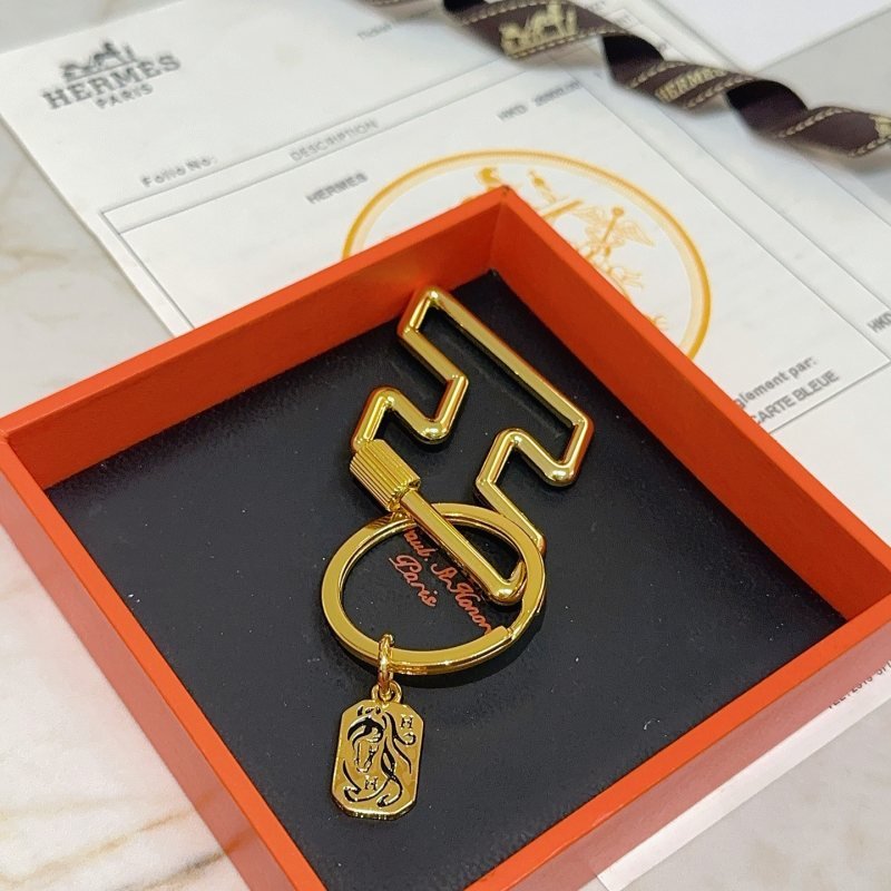 Hermes Cheval Horse Tag Zigzag Key Holder pendant gold tone metal with black enamel detailing 8cm total length