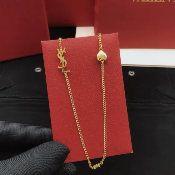Saint Laurent YSL Monogram Heart Crystal Chain necklace gold-tone metal with clear faceted crystal and polished gold heart charm 42cm with 5cm extender