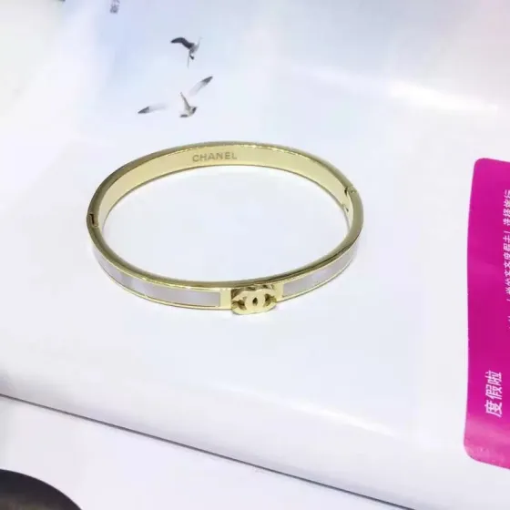 Chanel CC Logo Hinged Bangle bracelet Gold-tone metal with white mother-of-pearl inlay Rose gold-tone metal with white mother-of-pearl inlay Silver-tone metal with white enamel inlay 17cm inner circumference