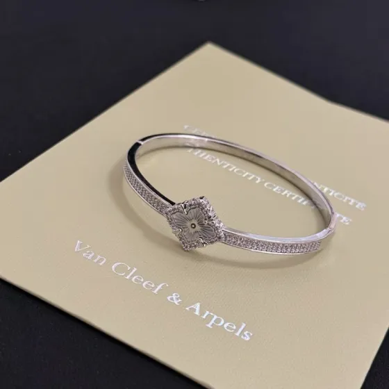 Van Cleef Arpels Alhambra bracelet silver-toned metal with clear diamond accents and silver guilloche clover motif 17cm