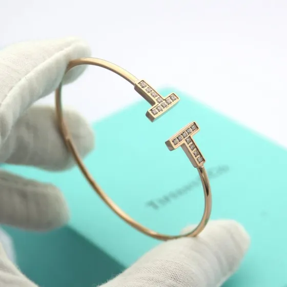 Tiffany Tiffany T bracelet Available in 18k rose gold 18k yellow gold and sterling silver all set with clear round brilliant diamonds 17cm inner circumference