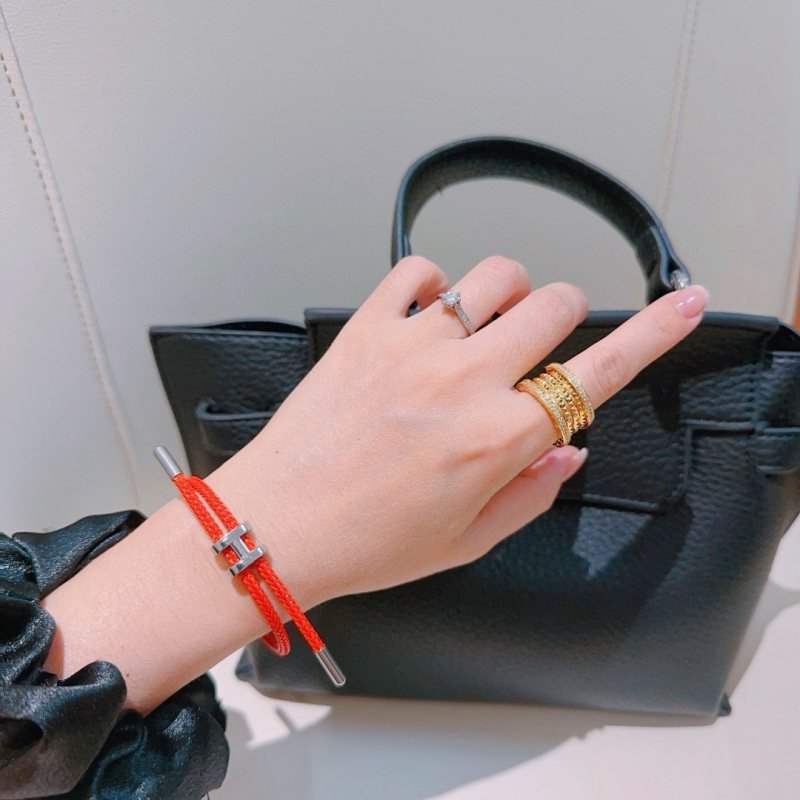 Hermes Tournis Tresse H bracelet Orange braided cord with silver-tone palladium plated H clasp and end caps Adjustable sliding design fits wrist sizes approximately 15cm to 19cm