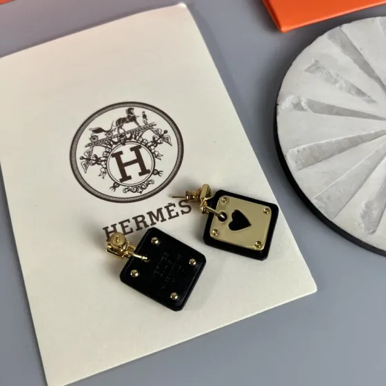 Hermes As de Coeur Swift Heart Stud Earrings earrings Gold-tone metal with black Swift leather black variant Gold-tone metal with red Swift leather red variant black or red heart cutout detail 2cm drop length