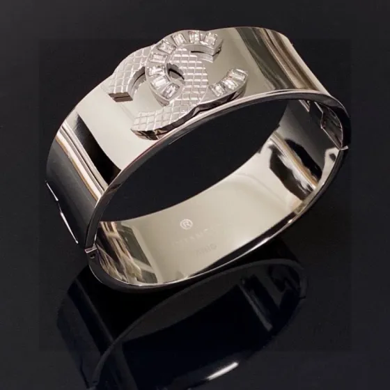 Chanel CC Logo Quilted Crystal Wide Cuff bracelet Silver-tone metal with clear baguette-cut crystals One Size standard wide cuff inner circumference 17cm