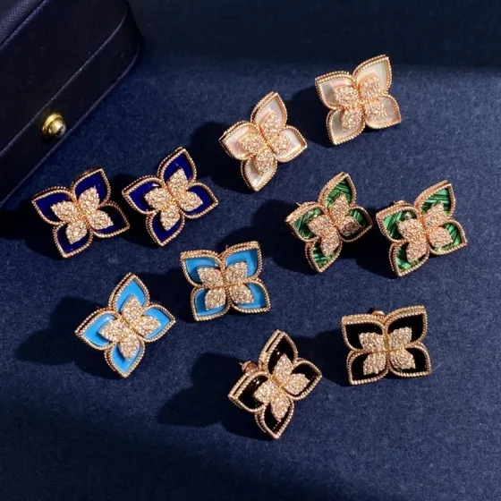 Roberto Coin Princess Flower earrings Available in rose gold yellow gold and white gold metal options with center pave diamonds and inlay options of white mother-of-pearl blue lapis lazuli turquoise green malachite and black onyx 15mm stud diameter