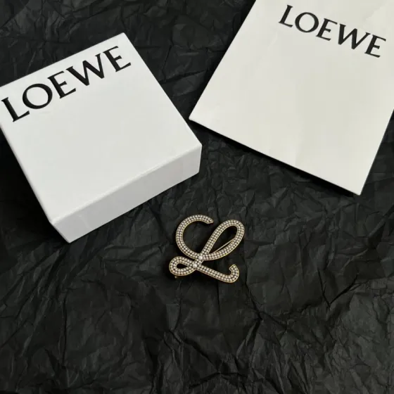 Loewe Anagram brooch antique gold tone metal with white faux pearl embellishments 4 5cm width