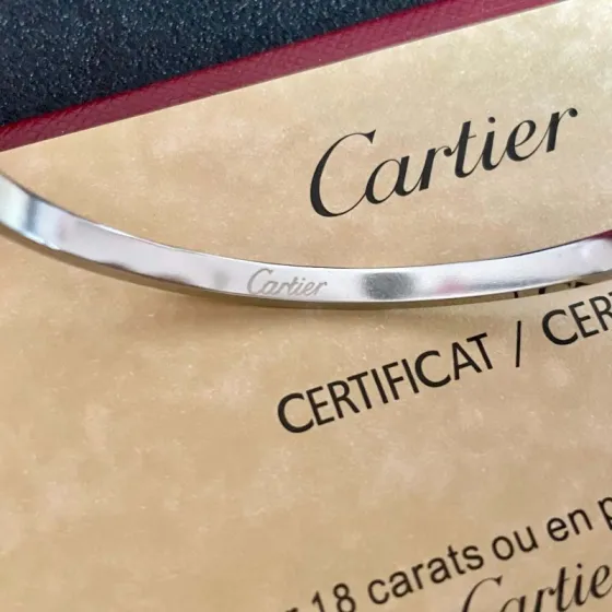 Cartier Love Interlocking Clasp Bangle bracelet Silver-toned metal with clear diamond accents 17
