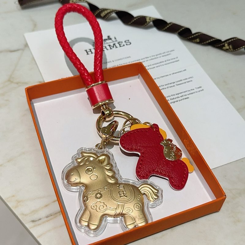 Hermes Rodeo Wealth Horse Keychain Charm pendant Red braided leather gold-tone metal matte gold horse charm with clear protective casing yellow leather accents 12cm total length