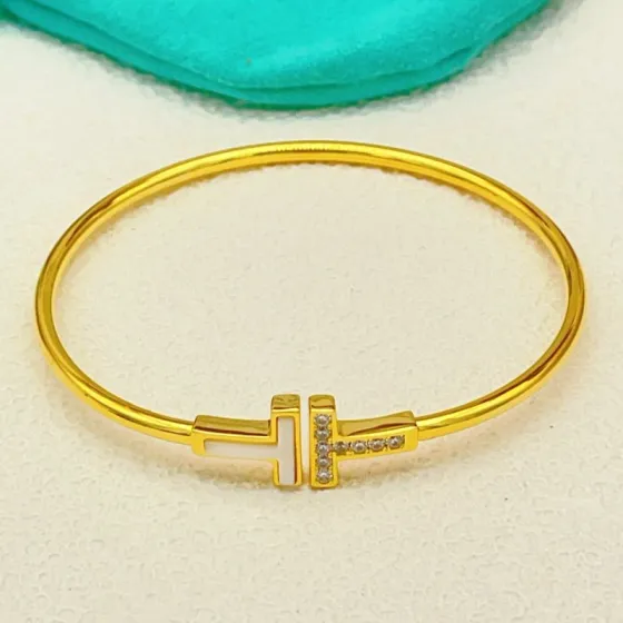 Tiffany Co T Wire bracelet yellow gold metal white mother-of-pearl clear diamond accents 17cm inner circumference