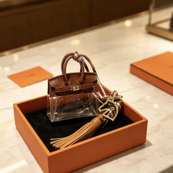 Hermes Birkin Micro Bag Charm pendant Gold-tone metal brown crocodile-embossed leather transparent PVC tan leather tassel multicolor printed silk twilly 12cm total length