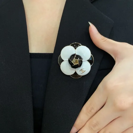 Chanel Camellia CC brooch gold tone metal black and white enamel 3 5cm diameter