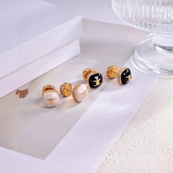Celine Triomphe Square Stud Earrings earrings Gold-tone metal with clear cubic zirconia accents available in black enamel and white mother-of-pearl face options with gold Triomphe logo 1cm stud diameter