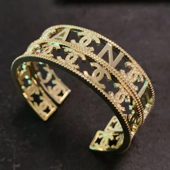 Chanel CC Logo Crystal Cutout Cuff bracelet gold-tone metal with clear crystal accents 17cm inner circumference