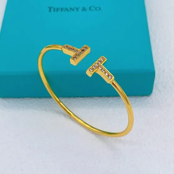Tiffany Co T Wire bracelet gold metal with clear diamond accents 17cm inner circumference