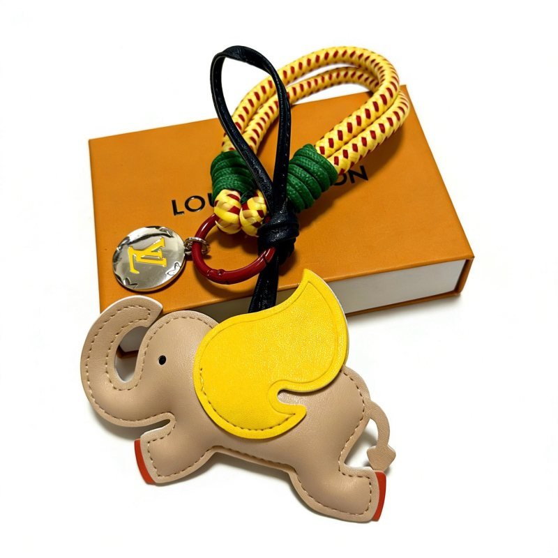 Louis Vuitton Anger Forest Elephant Charm Keychain pendant Beige leather with yellow leather ear red painted feet yellow and red braided cord green cord wrap black leather strap red enamel metal ring silver-tone metal with yellow LV logo charm 18cm strap length