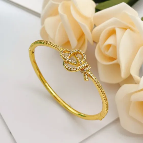 Tiffany Co Knot bracelet yellow gold with clear diamond accents 17cm inner circumference