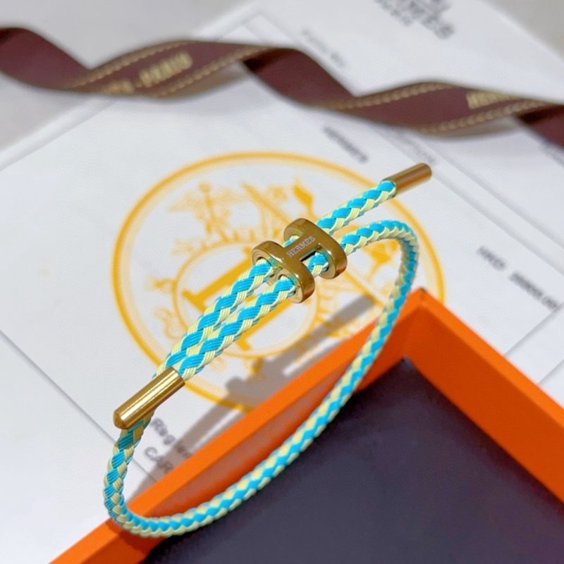 Hermes H d Ancre bracelet gold-tone metal turquoise and pale yellow braided cord adjustable