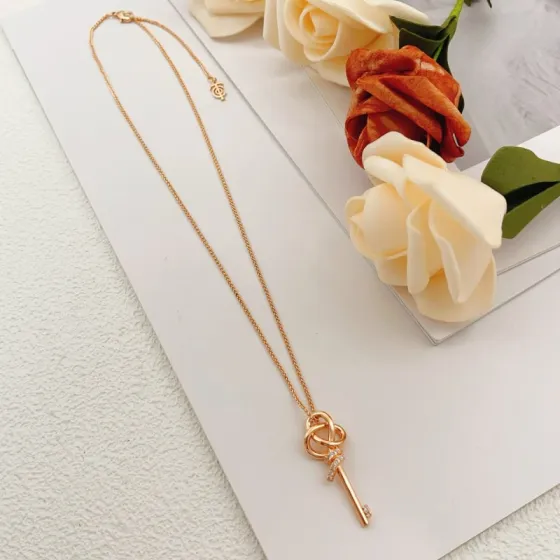 Tiffany Co Tiffany Keys Woven Key Pendant necklace 18k rose gold with clear diamond accents 18 inch chain