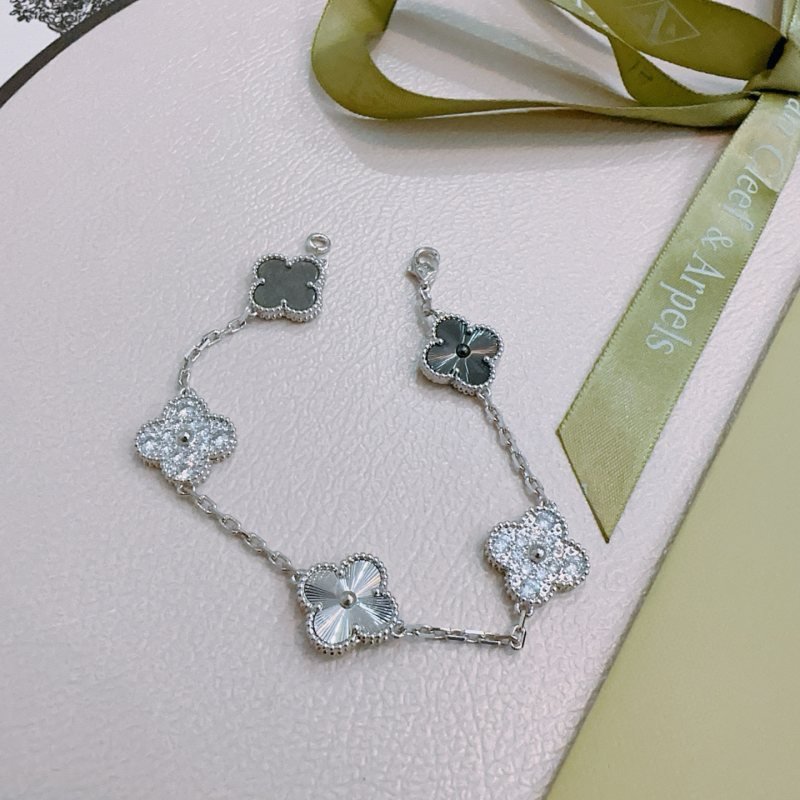 Van Cleef Arpels Alhambra bracelet silver-toned metal with clear diamond accents dark gray stone and silver guilloche clover motifs 17cm