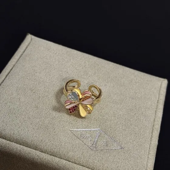 Van Cleef Arpels Alhambra Four Leaf Clover ring yellow gold metal with multicolor enamel and pave set clear red orange yellow gemstones adjustable open band