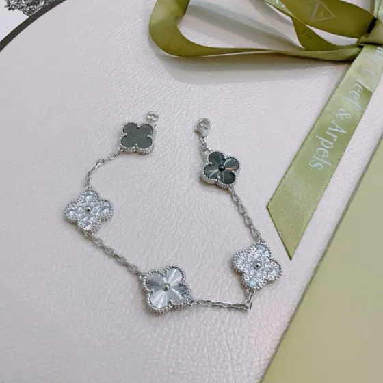 Van Cleef Arpels Alhambra bracelet Silver-toned metal with clear diamond-like stones dark gray clover inlays and silver guilloche clover motifs 17cm