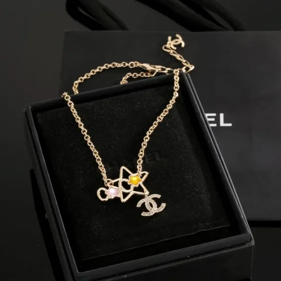 Chanel CC Star Charm necklace gold-tone metal with clear crystals pink and yellow star accents 42cm with 5cm extender