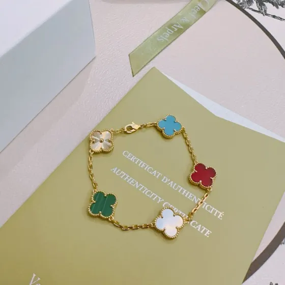 Van Cleef Arpels Alhambra bracelet Yellow gold metal with turquoise blue carnelian red malachite green white mother-of-pearl and gold guilloche clover motifs 17cm