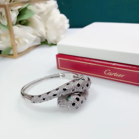 Cartier Panthere de Cartier bracelet 18K white gold set with colorless diamonds black onyx spots green tsavorite garnet eyes 17cm inner circumference