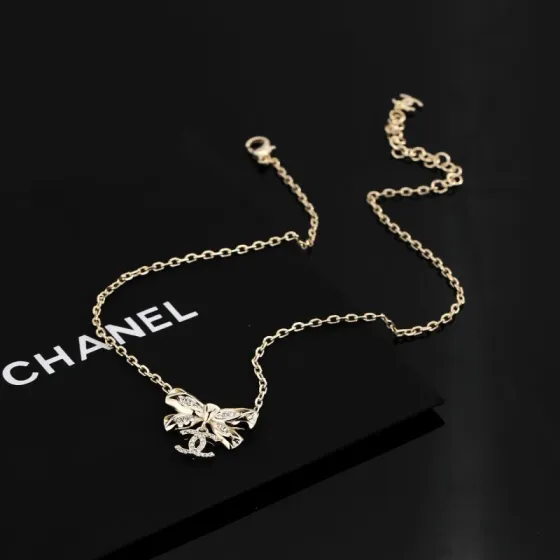 Chanel Crystal Bow CC Pendant Necklace necklace Light gold tone metal with clear crystal accents 42cm with 5cm extender