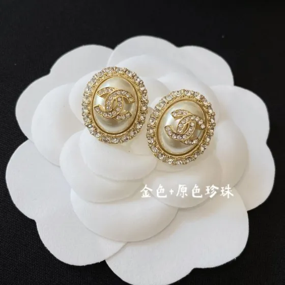 Chanel earrings Gold-tone metal with clear crystals available in cream pearl and black resin center options 1 5cm diameter
