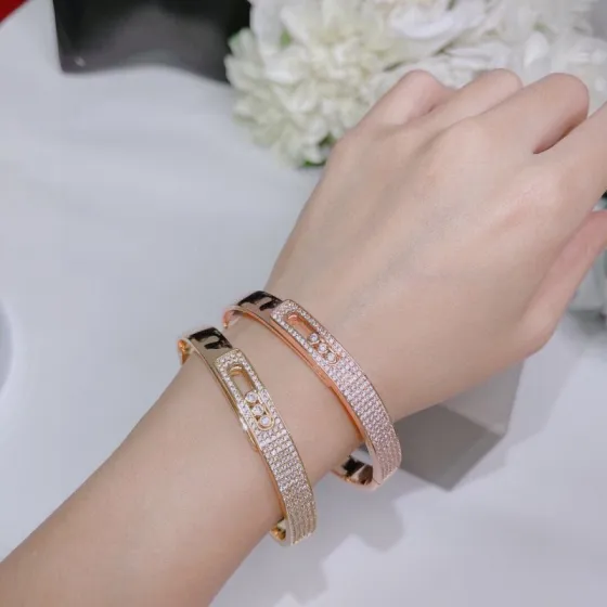 Messika Move Series Pave Bangle bracelet Available in 18k rose gold 18k yellow gold 18k white gold all set with pave white diamonds and three sliding brilliant-cut white diamonds 17cm inner circumference