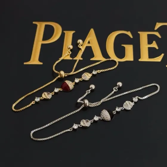 Piaget Possession bracelet yellow gold metal clear diamond-like crystals deep red enamel accent adjustable sliding chain 16-20cm