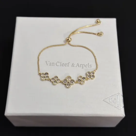 Van Cleef Arpels Alhambra bracelet gold-toned metal with clear faceted stone accents adjustable slider chain maximum length 22cm