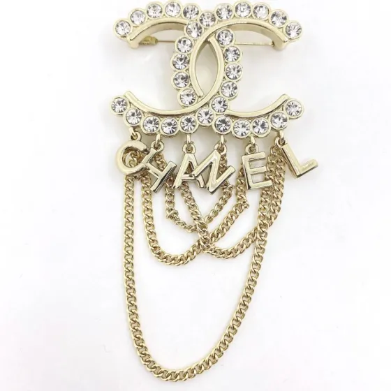 Chanel CC Logo Letter Chain Fringe Brooch brooch Gold-tone metal with clear faceted crystal accents Approximately 6cm width 9cm total drop length with chains