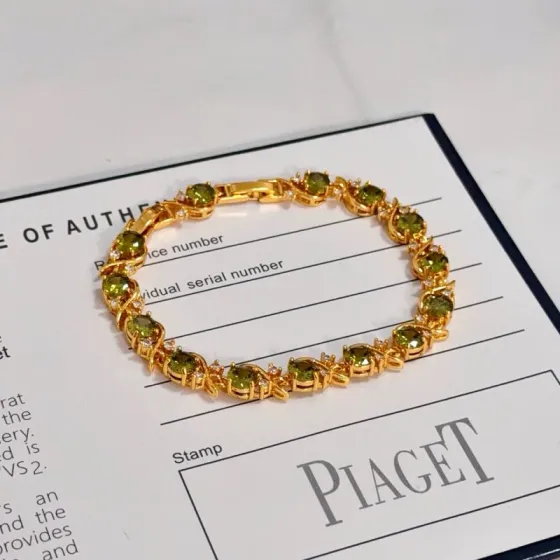 Piaget Rose Vine Gemstone Line Bracelet bracelet Yellow gold metal with peridot green gemstones and clear diamond accent stones 18cm