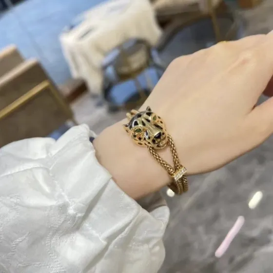 Cartier Panthere de Cartier bracelet 18k yellow gold black lacquer spots emerald green eyes diamond accent on slider adjustable sliding chain fits 15-19cm wrist