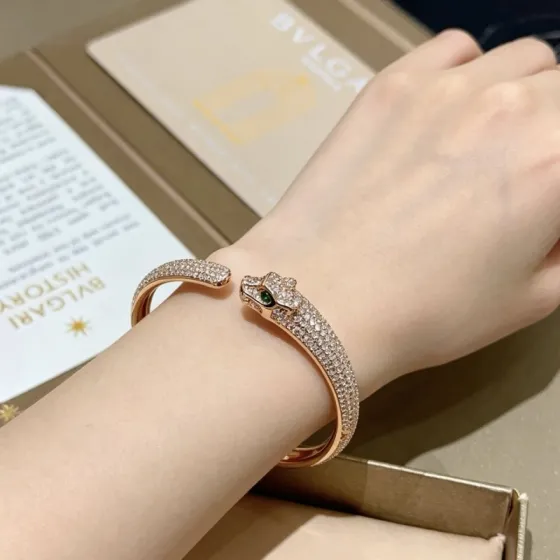 Cartier Panthere de Cartier bracelet 18K rose gold pave set white diamonds green tsavorite garnet eyes 17