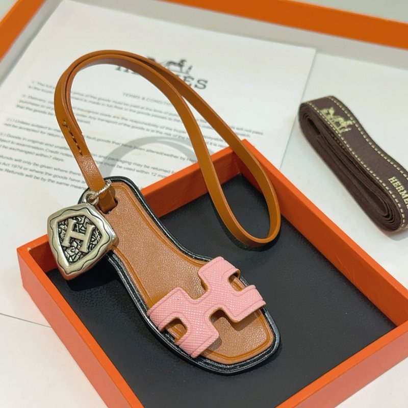 Hermes Oran Sandal Bag Charm pendant tan leather pink Epsom leather antique silver-tone metal black edge trim 17cm strap length