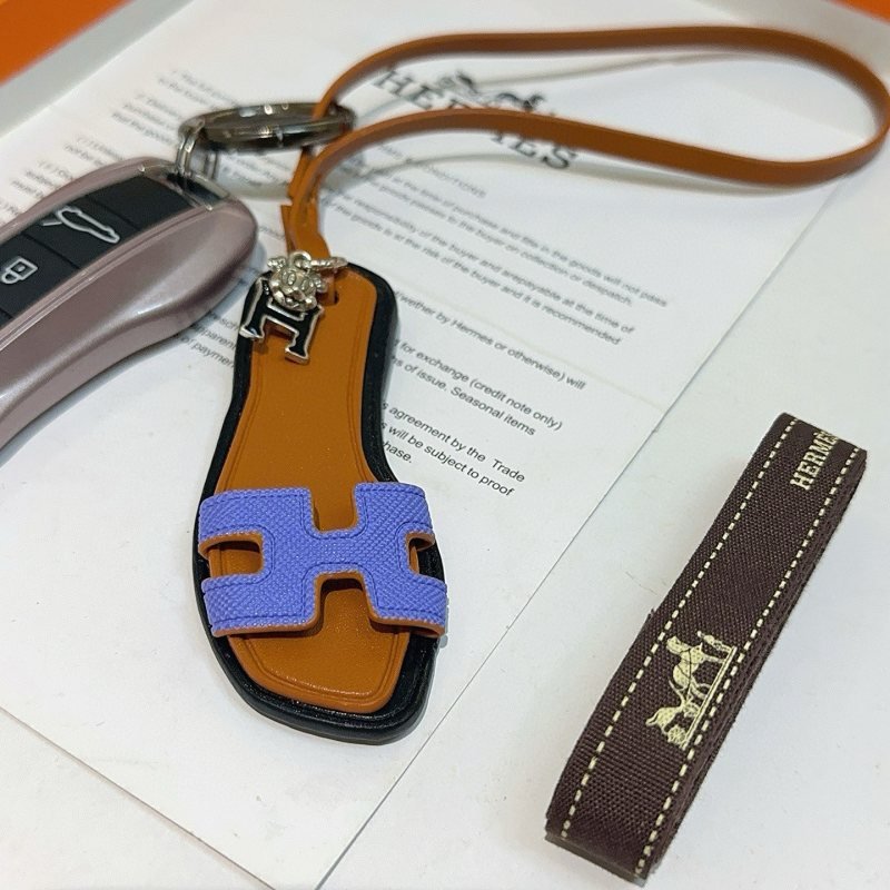 Hermes Oran Sandal Charm pendant tan leather black trim lavender purple H strap silver tone metal hardware 17cm lanyard length