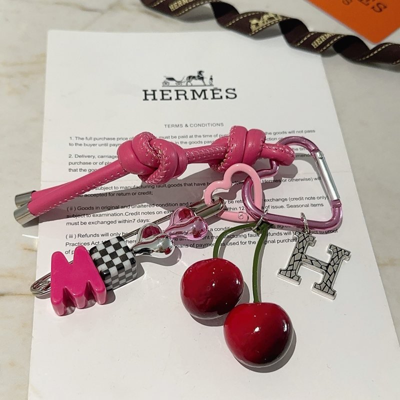 Hermes Cherry H Logo Knot Bag Charm Keychain pendant Hot pink leather silver-tone metal red cherry accents black and white checkered detail pink heart hardware green cherry stems 10cm