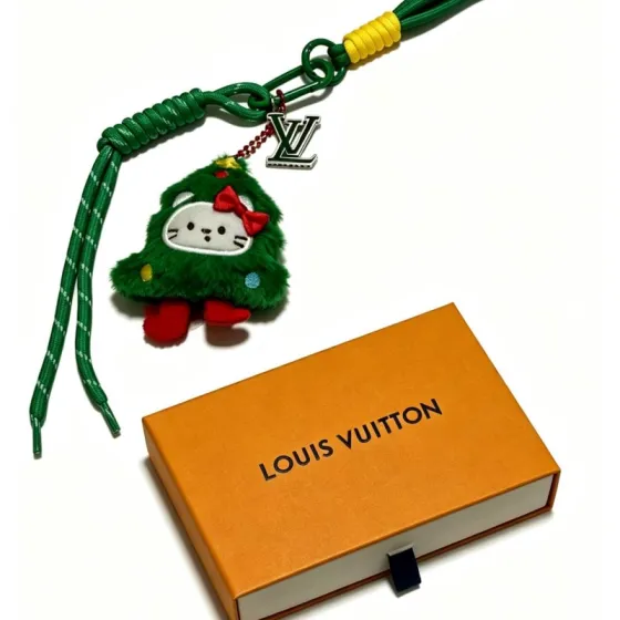 Louis Vuitton Anger Forest Christmas Tree Hello Kitty Charm Keychain pendant Green cord with yellow wrap silver-tone LV logo charm green plush charm with red bow feet white face yellow and blue accent dots 20cm total strap length