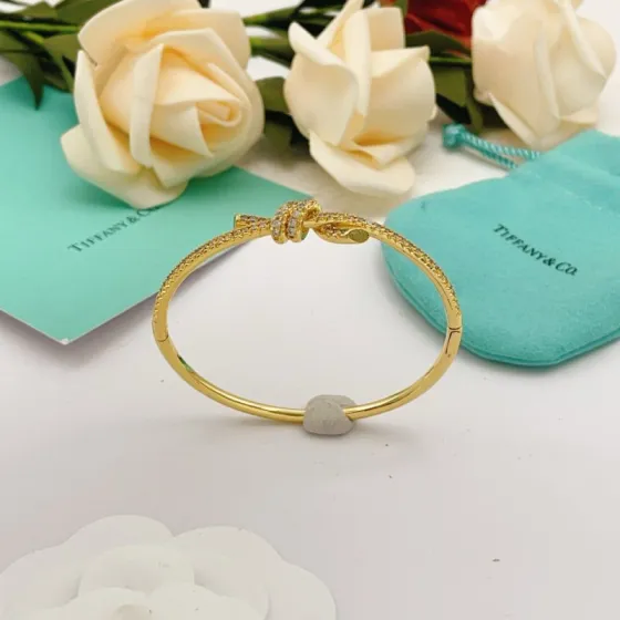 Tiffany Co Knot bracelet yellow gold metal with clear pave diamonds 17cm inner circumference