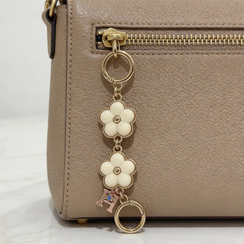 Hermes Flower H Logo Bag Charm Key Holder pendant Gold-tone metal with cream white enamel flower accents rose gold H charm with blue enamel detail 8cm total length